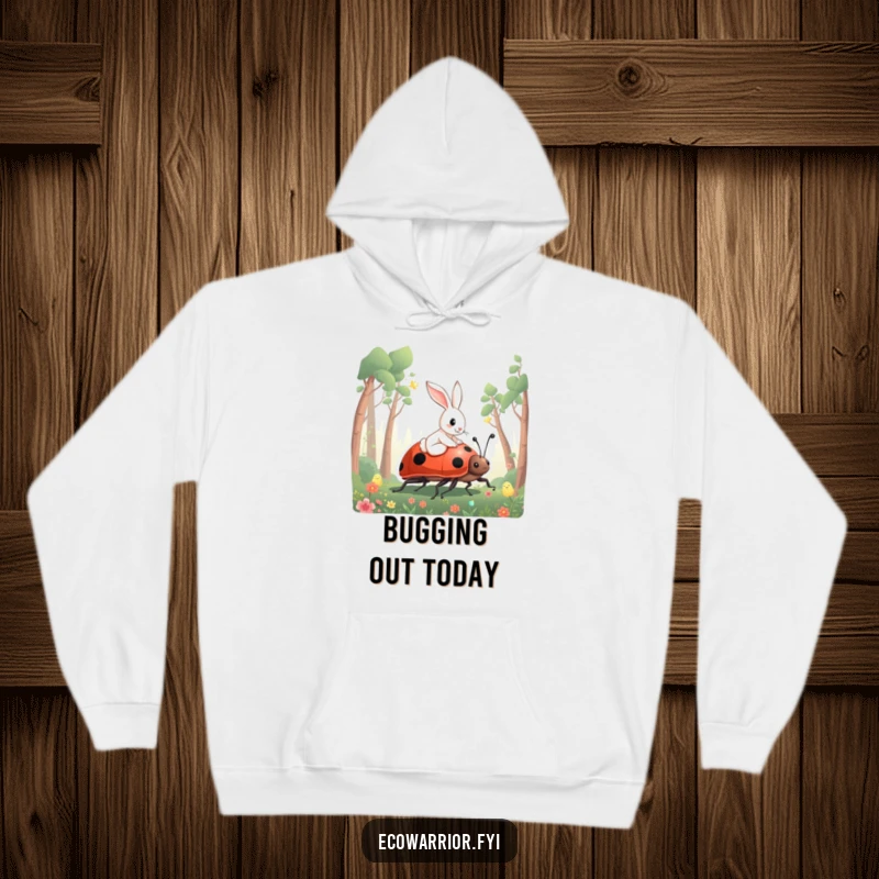 Funny Rabbit Hoodie featuring a curious rabbit riding a giant ladybug through a forest, offering cozy enchantment.