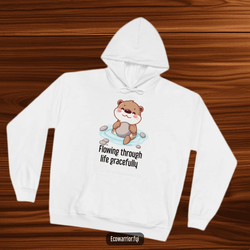 Funny hoodie depicting a happy otter swimming in water while holding a smooth stone, ideal for cozy humor.