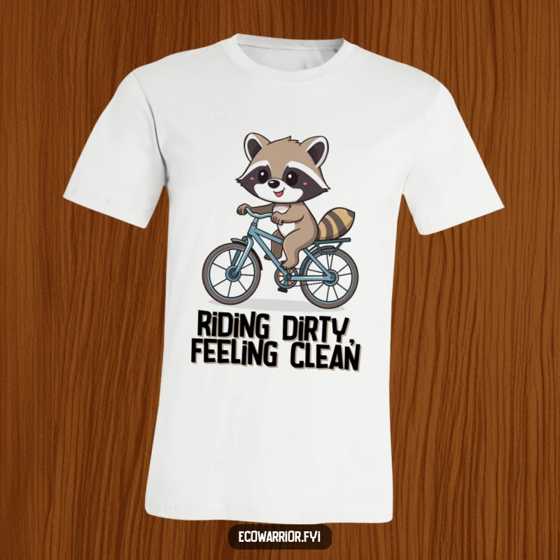 Funny t-shirt depicting a smiling raccoon cycling on a bike made from recycled parts, celebrating resourcefulness and joy.
